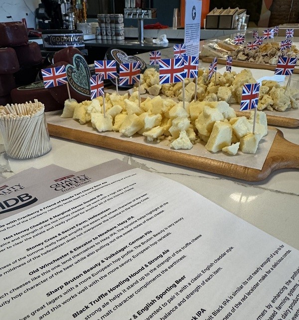 Cheese on a wooden board with United Kingdom flags.